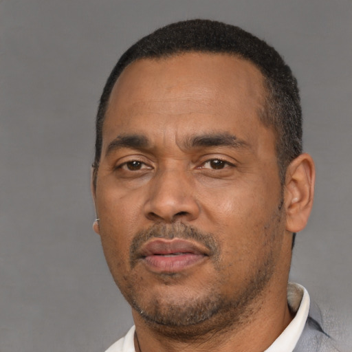 Neutral black adult male with short  black hair and brown eyes