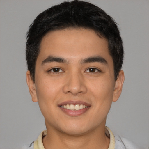 Joyful latino young-adult male with short  brown hair and brown eyes
