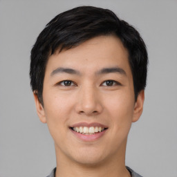 Joyful asian young-adult male with short  black hair and brown eyes