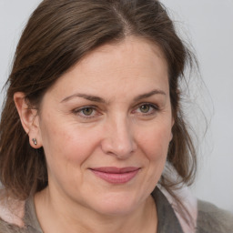 Joyful white adult female with medium  brown hair and grey eyes