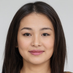 Joyful asian young-adult female with long  brown hair and brown eyes