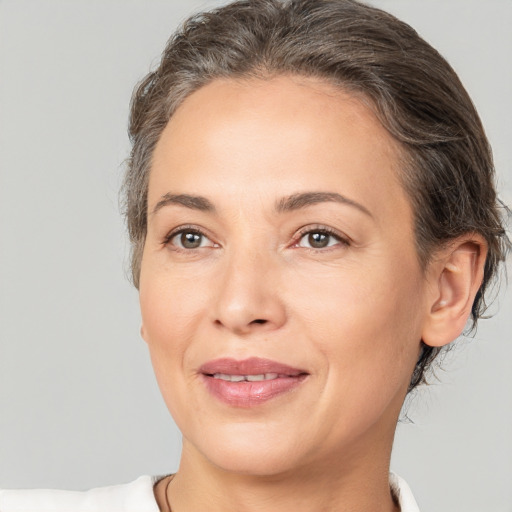 Joyful white adult female with short  brown hair and brown eyes