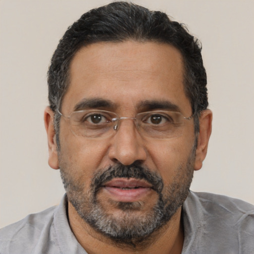 Joyful black adult male with short  black hair and brown eyes