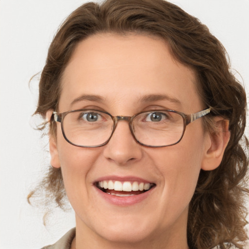 Joyful white adult female with medium  brown hair and green eyes