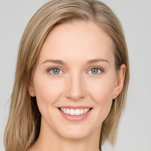 Joyful white young-adult female with long  brown hair and blue eyes