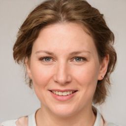 Joyful white adult female with medium  brown hair and blue eyes