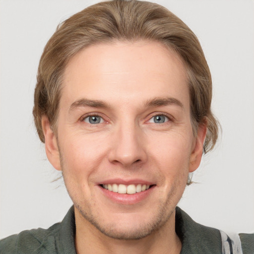 Joyful white adult male with short  brown hair and grey eyes