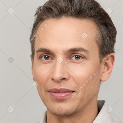 Joyful white adult male with short  brown hair and brown eyes