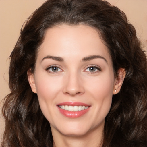 Joyful white young-adult female with long  brown hair and brown eyes