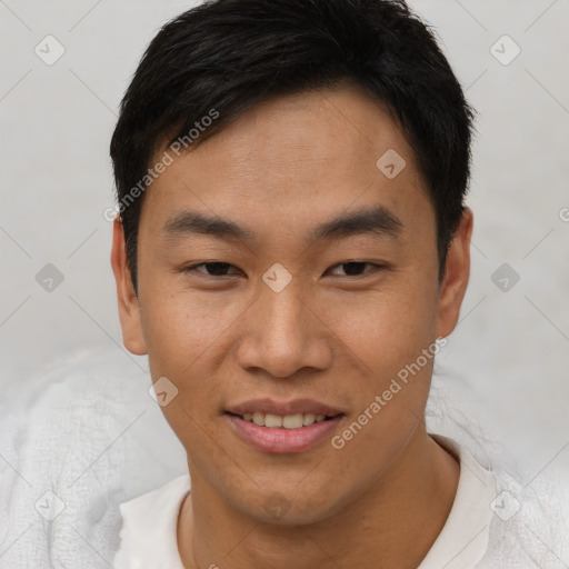 Joyful asian young-adult male with short  brown hair and brown eyes