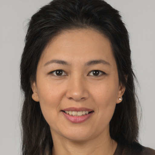 Joyful latino young-adult female with long  brown hair and brown eyes