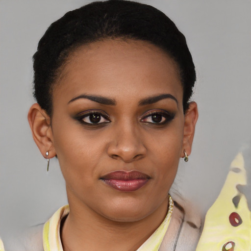 Joyful black young-adult female with short  brown hair and brown eyes