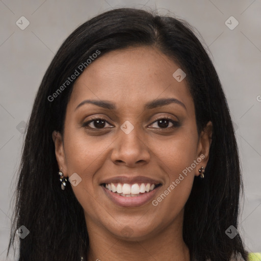 Joyful black young-adult female with long  brown hair and brown eyes