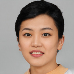 Joyful asian young-adult female with short  black hair and brown eyes