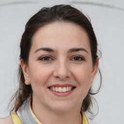 Joyful white young-adult female with medium  brown hair and brown eyes