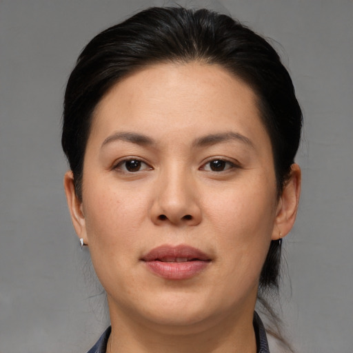 Joyful asian adult female with medium  brown hair and brown eyes