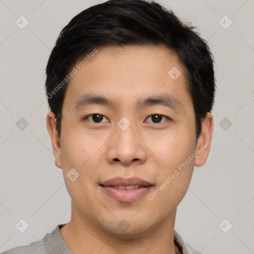 Joyful asian young-adult male with short  black hair and brown eyes