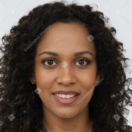 Joyful black young-adult female with long  brown hair and brown eyes