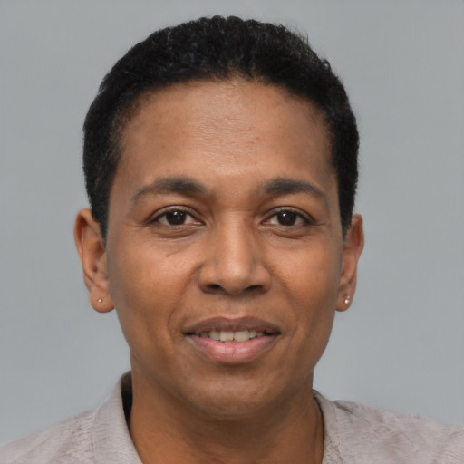 Joyful black young-adult male with short  black hair and brown eyes