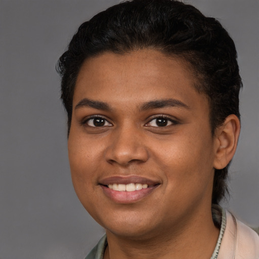 Joyful black young-adult female with short  brown hair and brown eyes