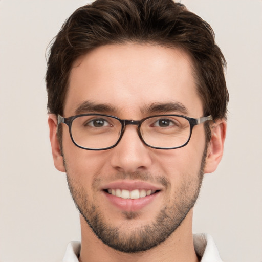 Joyful white young-adult male with short  brown hair and green eyes