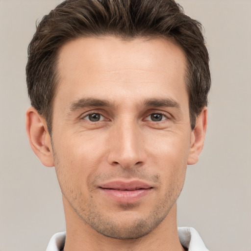 Joyful white young-adult male with short  brown hair and brown eyes