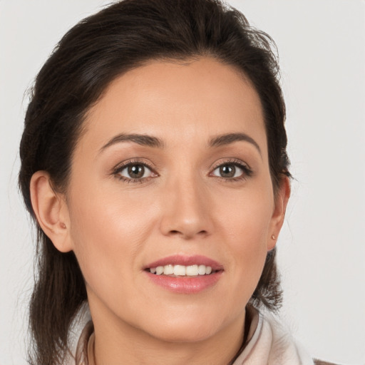 Joyful white young-adult female with medium  brown hair and brown eyes