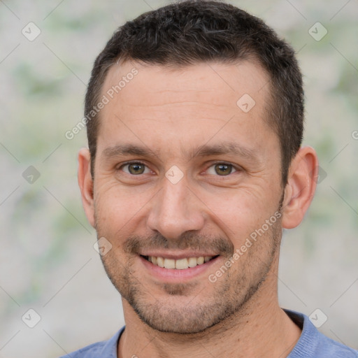 Joyful white adult male with short  brown hair and brown eyes