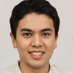 Joyful latino young-adult male with short  brown hair and brown eyes