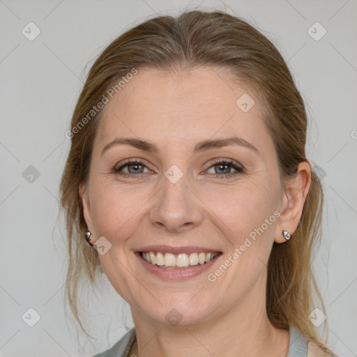 Joyful white adult female with medium  brown hair and grey eyes