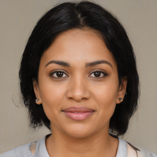 Joyful latino young-adult female with medium  black hair and brown eyes