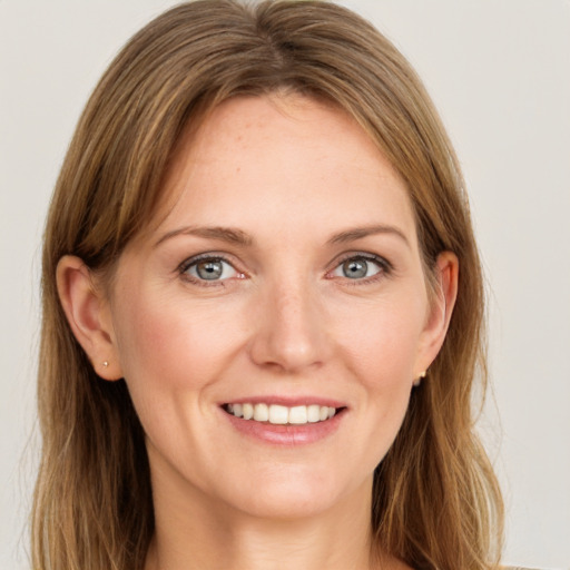 Joyful white young-adult female with long  brown hair and grey eyes