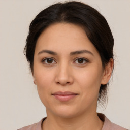 Joyful white young-adult female with medium  brown hair and brown eyes