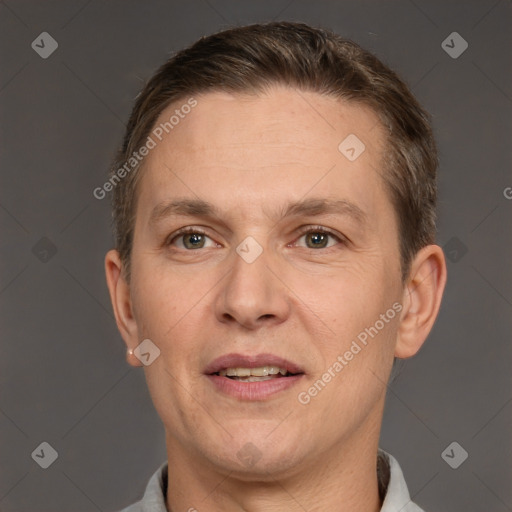 Joyful white adult male with short  brown hair and grey eyes