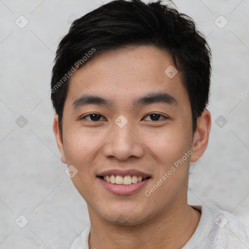 Joyful asian young-adult male with short  black hair and brown eyes