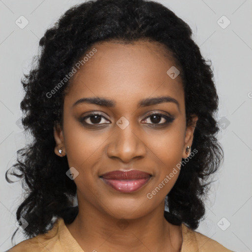 Joyful black young-adult female with long  black hair and brown eyes