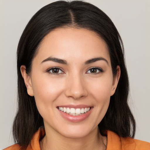 Joyful white young-adult female with long  brown hair and brown eyes