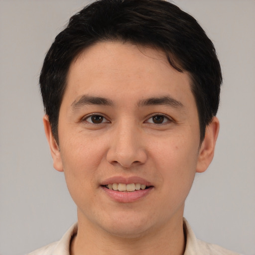 Joyful asian young-adult male with short  brown hair and brown eyes