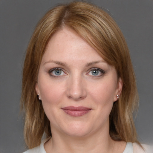 Joyful white young-adult female with medium  brown hair and blue eyes