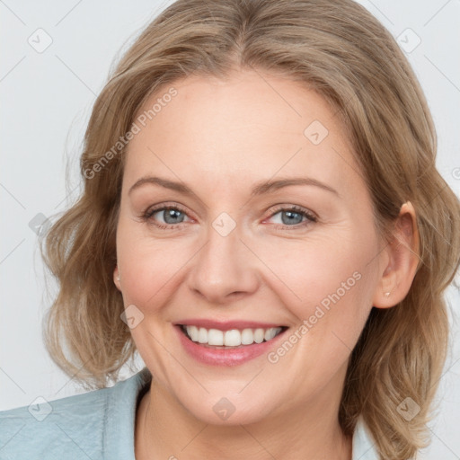 Joyful white adult female with medium  brown hair and blue eyes