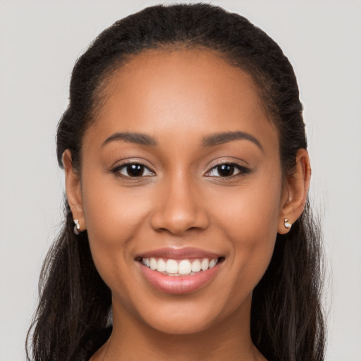 Joyful latino young-adult female with long  brown hair and brown eyes