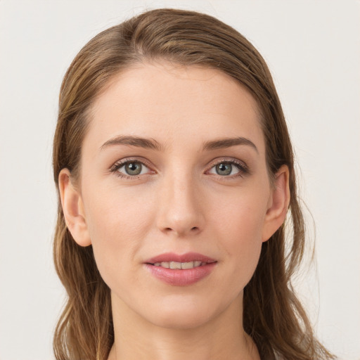 Joyful white young-adult female with long  brown hair and grey eyes