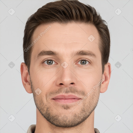 Joyful white young-adult male with short  brown hair and grey eyes