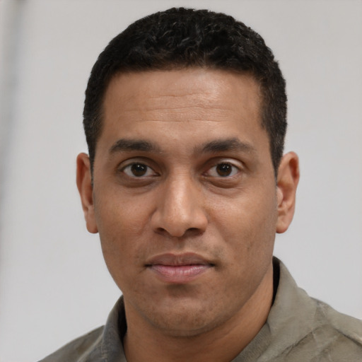 Joyful white young-adult male with short  black hair and brown eyes
