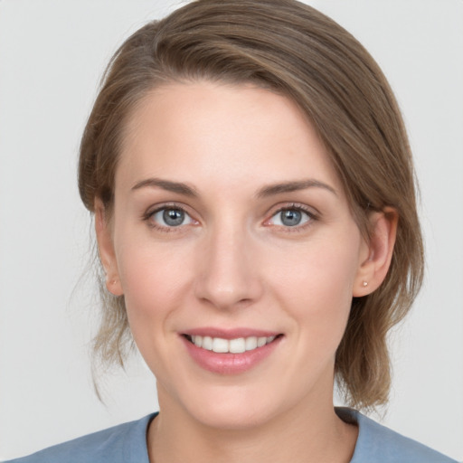 Joyful white young-adult female with medium  brown hair and grey eyes