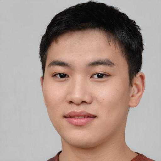 Joyful asian young-adult male with short  black hair and brown eyes