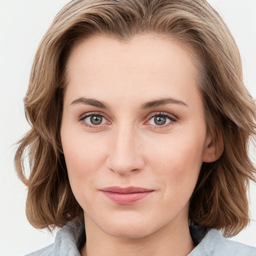 Joyful white young-adult female with medium  brown hair and blue eyes