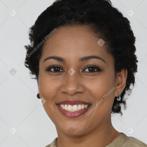 Joyful black young-adult female with short  black hair and brown eyes