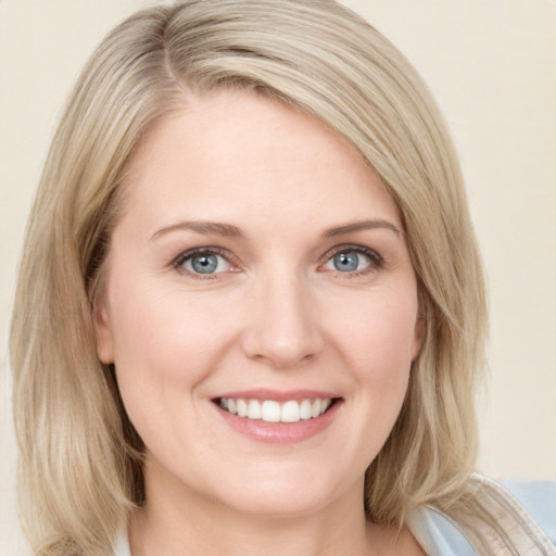 Joyful white young-adult female with medium  blond hair and blue eyes