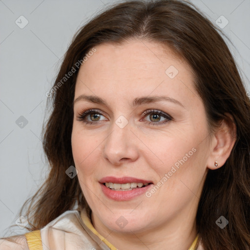 Joyful white adult female with medium  brown hair and brown eyes